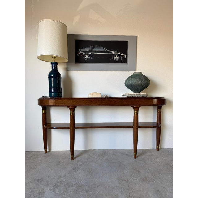 Elegant large French Art Deco Empire-style demilune console table featuring a beautifully crafted mahogany wood frame with...