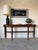 Elegant large French Art Deco Empire-style demilune console table featuring a beautifully crafted mahogany wood frame with...