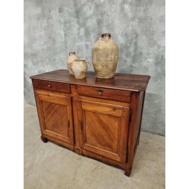 Antique buffet cabinet from France from around 1850. This cupboard is made of mahogany, oak and cherry wood. The cabinet...