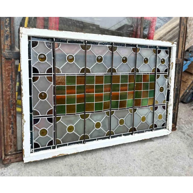 Antique, geometric patterned skylight with leaded, stained and textured glass. This whimsically designed window has a...