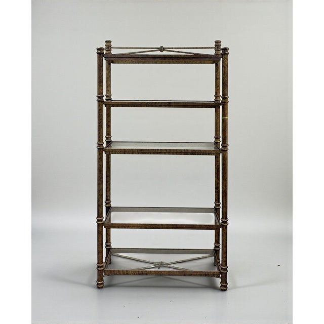 An aged metal etagere display or bookcase. Features five inset glass shelves with lovely knotted metal/iron accents....