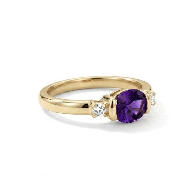 Sophisticated, contemporary, and beautifully minimalist. This exquisite three-stone ring features a stunning 6x4mm oval-...
