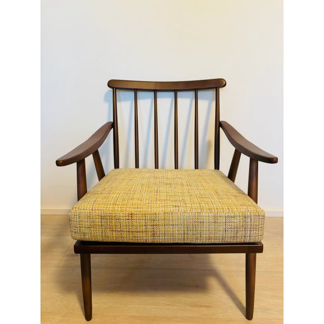 The simple Model 6971 chair with removable cushions supported by ribbons is a typical post-war product. Smidek's design...