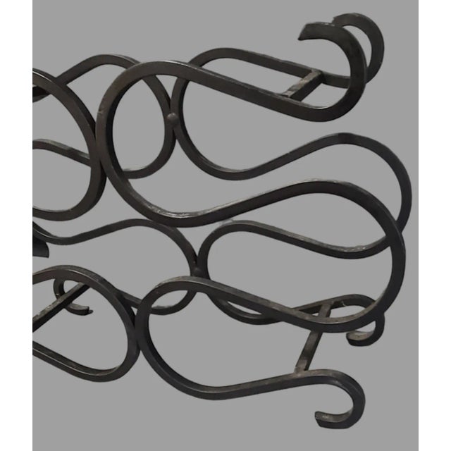 This vintage mid-century modern wine holder rack features a unique shape that is perfect for displaying up to six bottles...