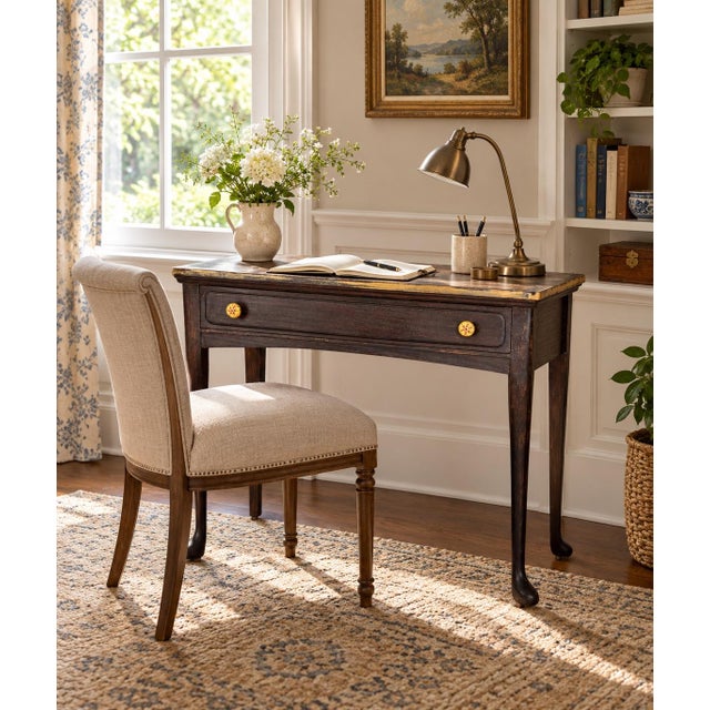 Charming vintage writing table or petite console featuring a slender dark-stained wood frame, elegant tapered legs and a...