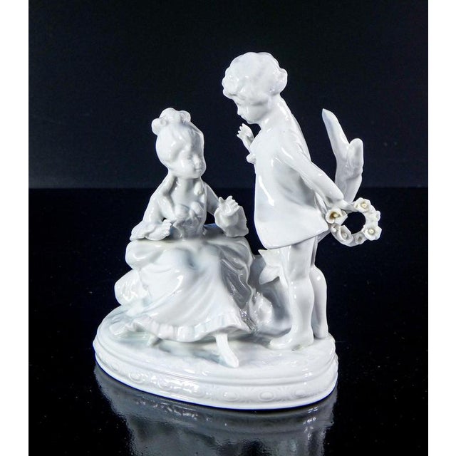 Capodimonte porcelain sculpture, gallant scene with young couple and garland of flowers. Italy, late 20th century origin...