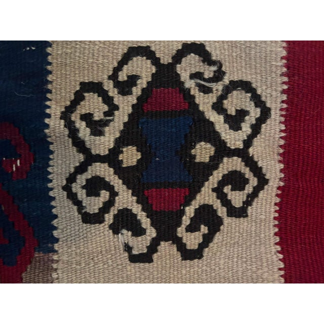 Vintage Turkish flat-weave kilim textile roll. Features repeating traditional tribal medallions woven onto a bold, solid...