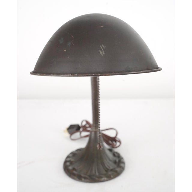 Early 20th century gooseneck office desk lamp made of a brown painted steel arm and shade and a cast iron base. It...