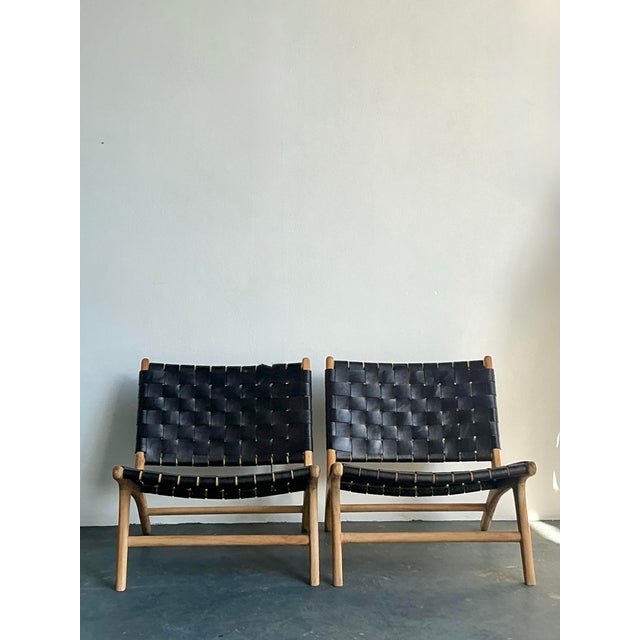 This striking pair of lounge chairs captures the essence of Mid-Century Modern design, drawing clear inspiration from the...