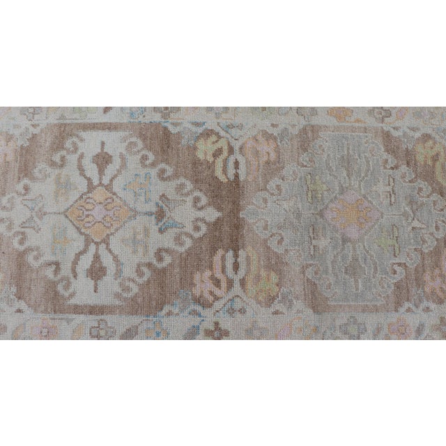 Early 21st Century Long Turkish Oushak Runner With Pale Blue, Soft Yellow, and Light Brown Motifs For Sale - Image 5 of 13