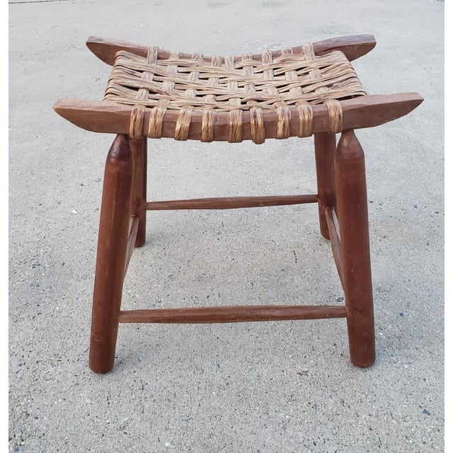 Brown woven vine and maple wood bench stool in bohemian style. Handwoven split vine stool with a beautiful curvy shape The...