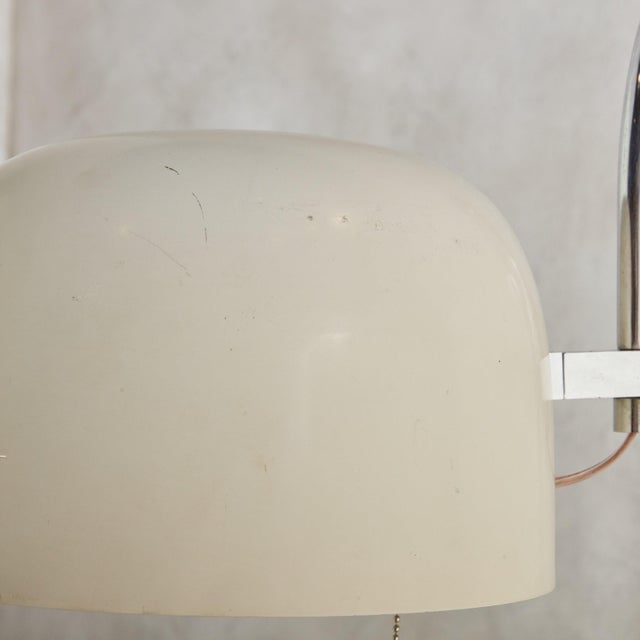 A striking 1970s Italian Modern floor lamp features a gracefully curved chrome arm that forms a sinuous, squiggle shape...