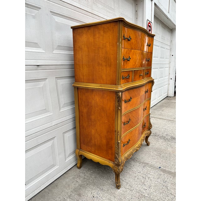 We have a beautiful vintage French Provincial highboy dresser for sale. This Louis XV style chest features a striking...