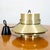 Tiered brass Danish pendant light fixture. Metallic exterior with a matte white interior. Unmarked example. Beautiful and...
