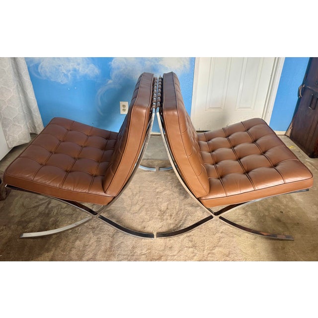 An exceptional matching pair of authentic Barcelona® Chairs manufactured by Knoll and designed by Ludwig Mies van der...