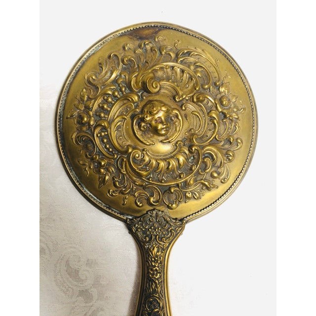 This antique Victorian hand mirror is a stunning piece of history. Crafted with gold and made in the United States, it...
