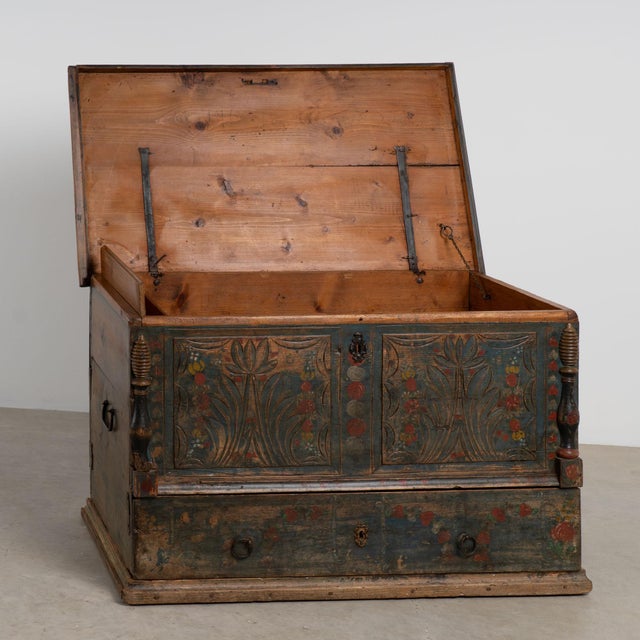 19th century Hungarian flat top trunk crafted in pine with original hand painted decoration. The surface features a blue...