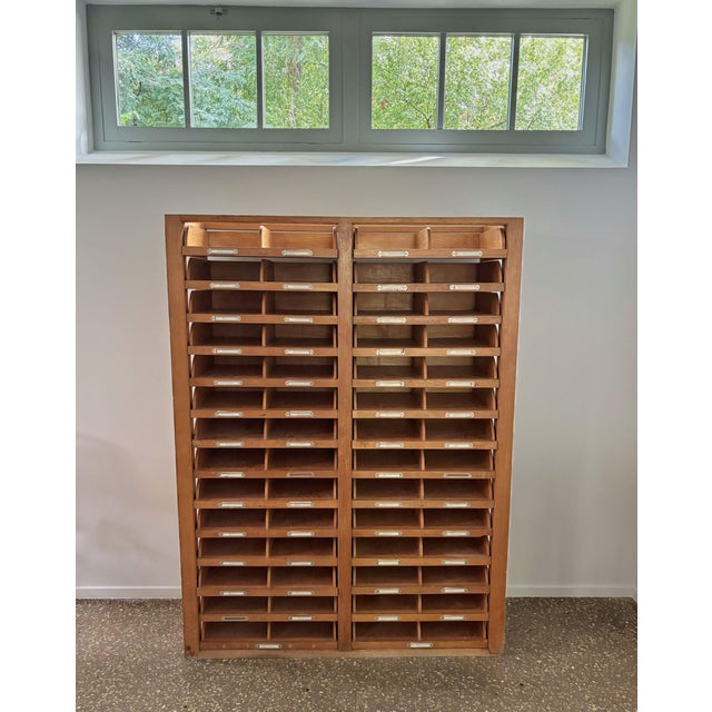 Wonderful wooden archive or filing cabinet. The cabinet has two sides, left and right, with both 14 drawers which can be...
