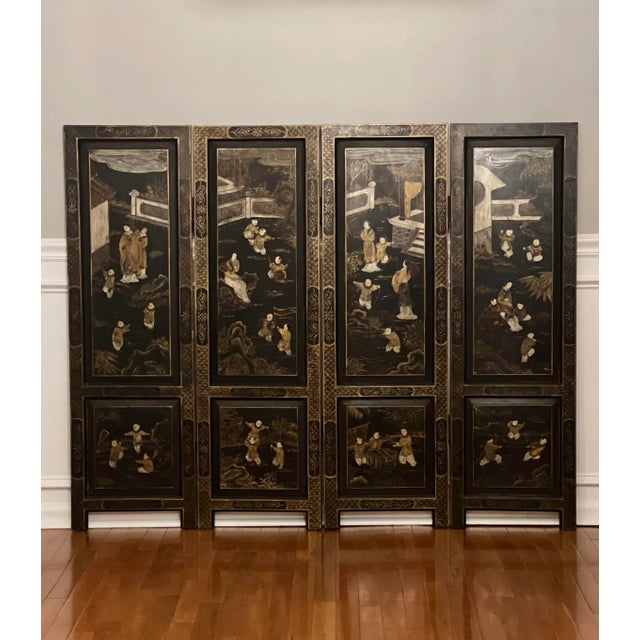 Chinese export smaller scale four-panel lacquered dressing screen room divider with hand-painted decoration on both sides....