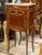 This elegant French Louis XV style bedside cabinet features a luxurious marble top, rich wood construction, and beautiful...