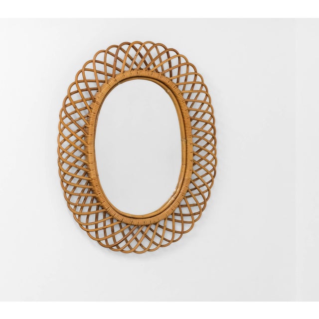 Italian mid century rattan and bamboo large oval wall mirror. Circa 1960. Attributed to Franco Albini. In excellent...