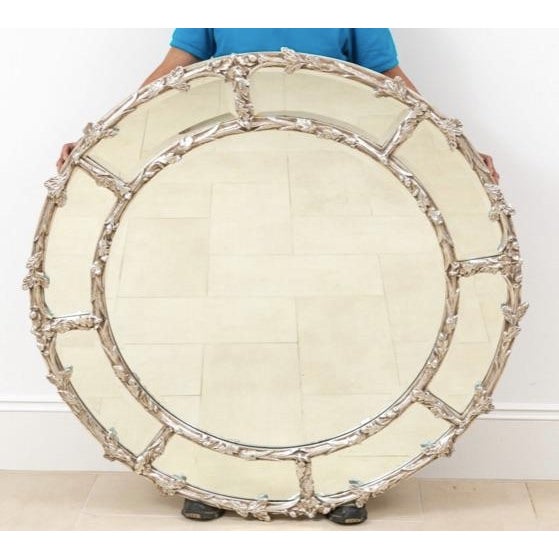 Louis XVI style round gilt wood and gesso mirror with silver leaf finish featuring acanthus leaf motif with beveled...