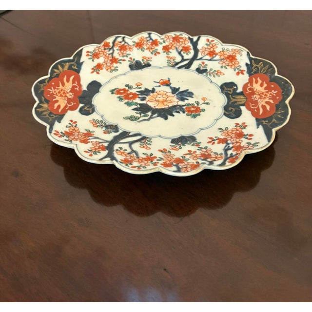 A finely decorated antique Japanese Imari dish of scalloped oval form, painted in the traditional Imari palette of...