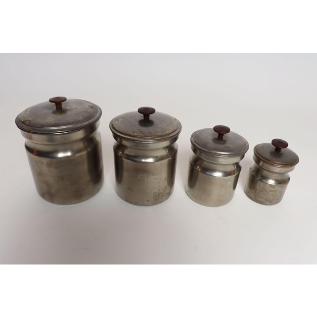 Set of four graduated/nesting metal kitchen canisters with teak pulls/handles by Tagus of Portugal (ca. 1970s). Naturally...
