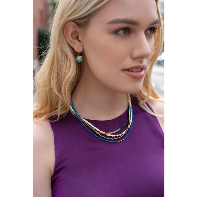Sleeping Beauty turquoise is the centerpiece of these bezel set in 18k gold vermeil pinwheels. The pinwheel earring is one...