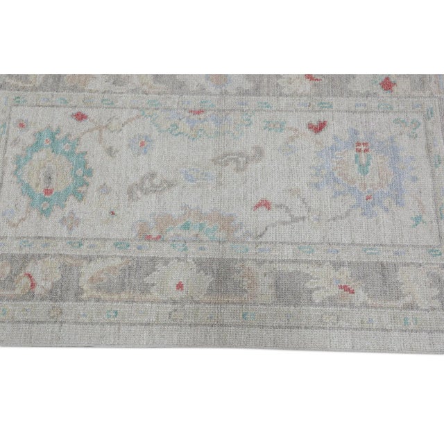 This modern Turkish Oushak rug is a stunning piece of art that has been handwoven using traditional techniques by skilled...