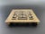 This vintage brass trivet features the Chinese Double Happiness symbol at the center, accented with engraved foliage...
