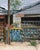 Palmer Street, 2019 presents a striking urban scene characterized by weathered buildings and vibrant graffiti. The artist...