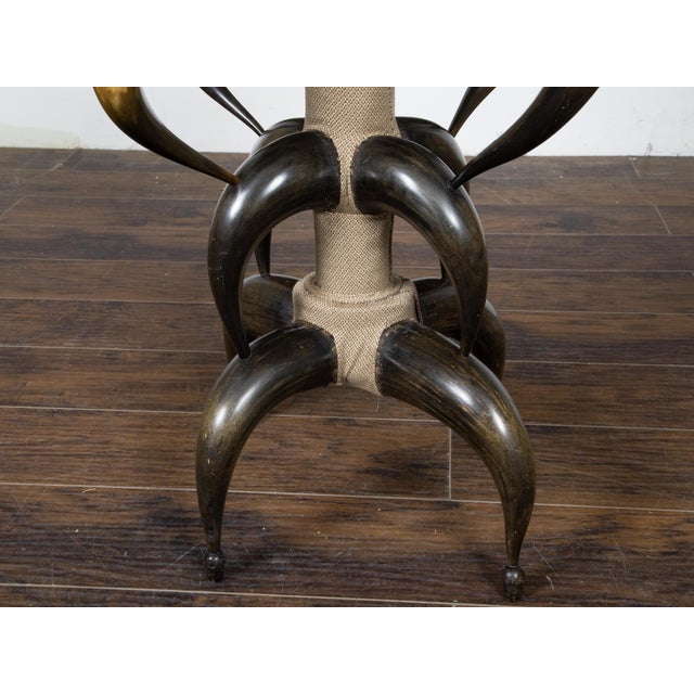 An American horn stool from circa 1880 with custom upholstery. This circa 1880 American horn stool stands as a remarkable...