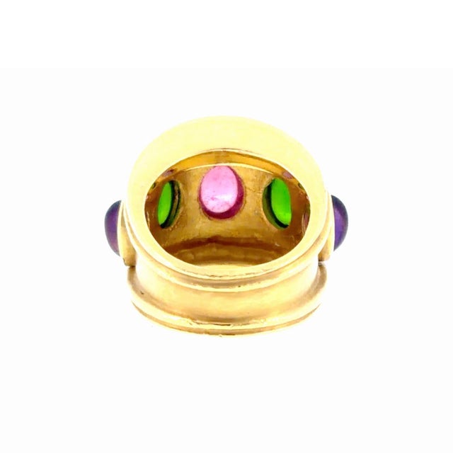 Vintage Seidengang 18K yellow gold multi color gemstone ring, featuring a graduating design of a wide band set with five...