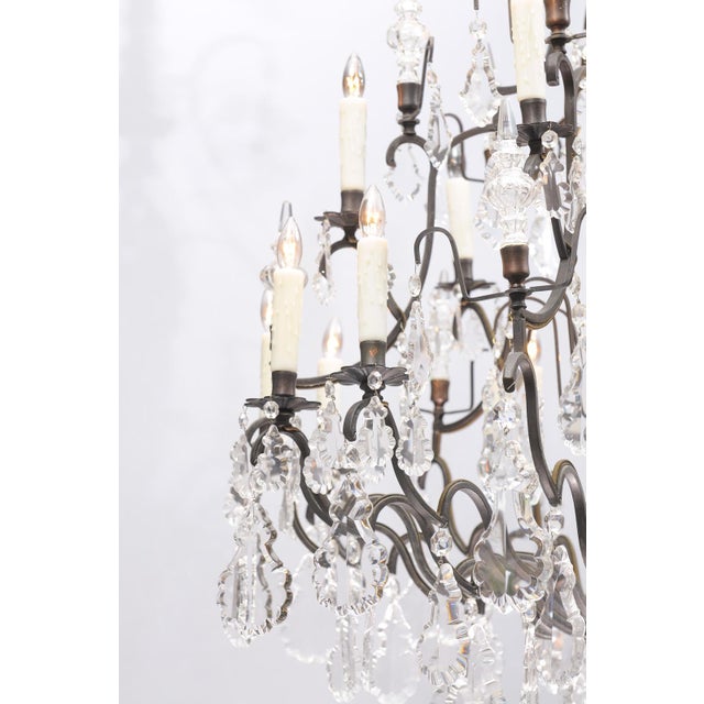 This piece is a truly stunning example of the Louis XV & Versailles style crystal chandeliers. The multi-tier bronze body...
