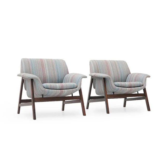Pair of Italian-made armchairs produced by Cassina in the 1950s, designed by Gianfranco Frattini. Wooden frame with curved...
