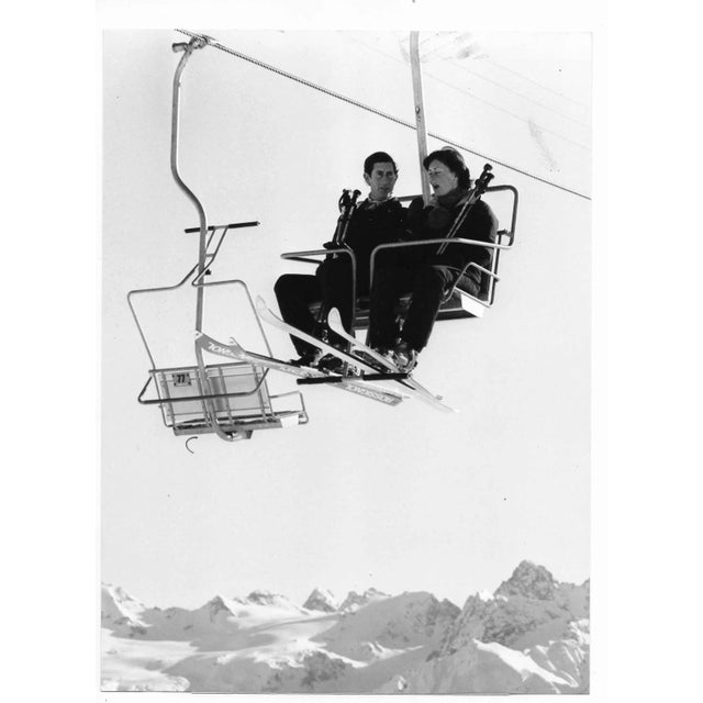 Black and white photo of Prince Charles and Patti Palmer-Tonkinson on a ski lift in Switzerland.