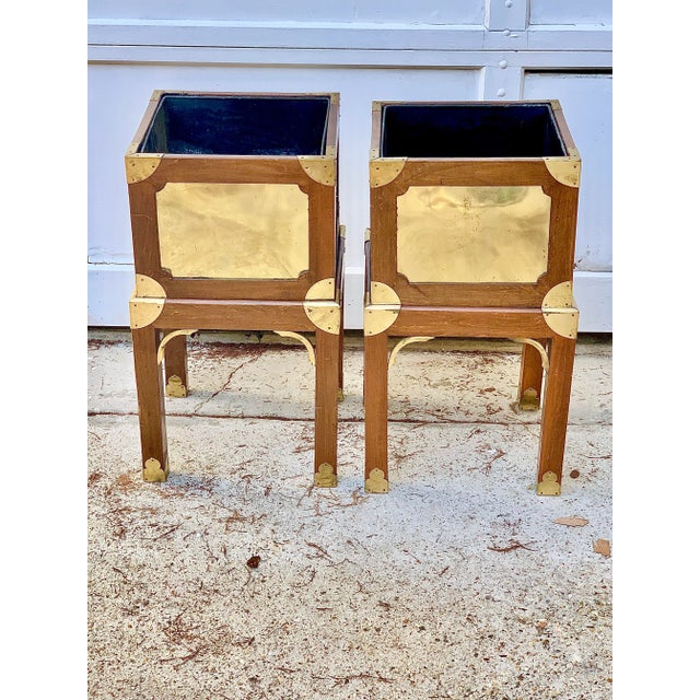 Fabulous vintage pair of plant stands. Made of wood and brass. Chinoiserie and campaign style design. The tops can be...
