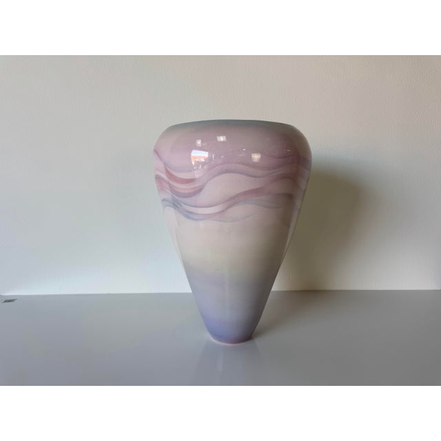 A beautiful 1980’s vintage art ceramic vase featuring a soft purple and lavender glazed finish with flowing abstract wave...