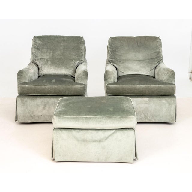 Pair of Baker Gray Velvet Upholstered Armchairs and Ottoman, with "Baker" label. Chair: 35" H x 31" W x 34" D; seat: 19"...