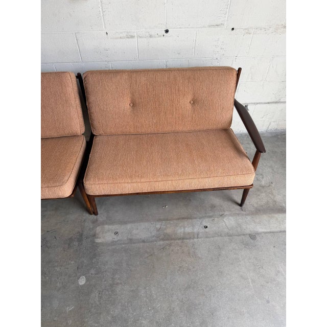 Beautiful Mid Century Modern sofa set, featuring a pair of matching loveseats and a coordinating coffee table. This...