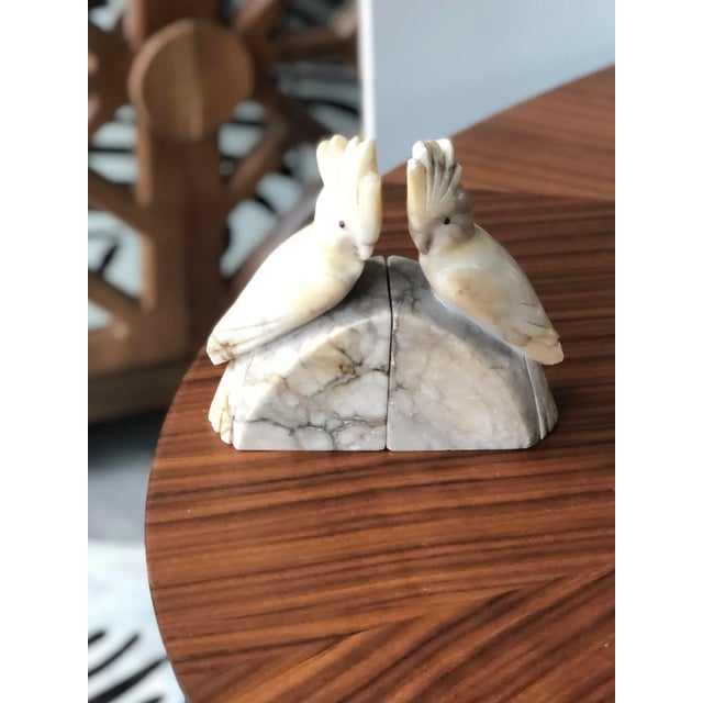 The beautiful marbling in this alabaster pair adds to the vintage Italian aesthetic. The hand-carved birds are each...