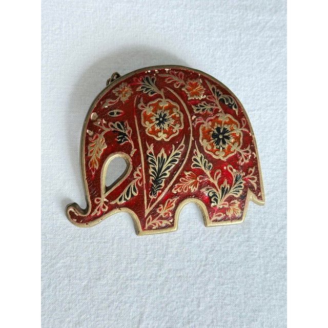 Vintage 1970s bohemian style brass elephant charm featuring a heavy solid brass body, short twisted rope chain, and...