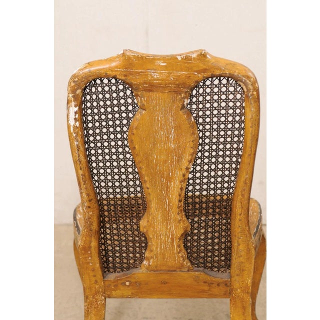 An Italian pair of wooden side chairs with chinoiserie and caning from the 18th century. This antique pair of chairs from...