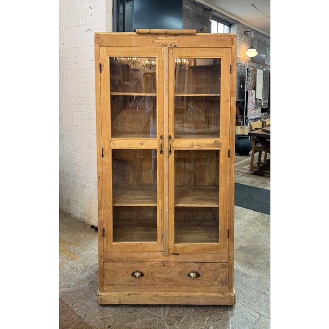 Beautifully crafted vintage wood cabinet featuring glass-paneled doors and rich natural patina. Constructed from reclaimed...