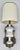 Here is a wonderful lamp from the early mid-century that features a beautiful, detailed lamp on a wood pedestal which is...