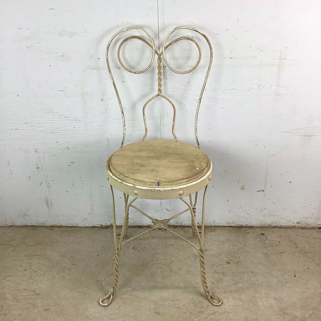 This charming vintage wrought iron ice cream parlor chair brings classic soda-fountain nostalgia into a modern setting....