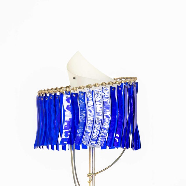 The "Priamo" floor lamp designed by Toni Cordero for Artemide from the Milano Torno Series, 1990. Patinated brass arm...