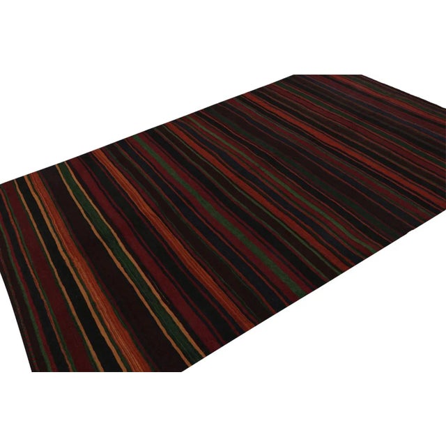 Hand knotted in wool, this 6x10 vintage Afghan tribal kilim rug, originating circa 1950-1960, is an exciting new addition...