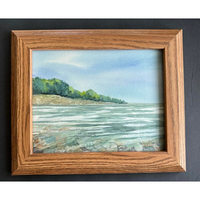 I have always loved collecting rocks. Here is scene where the rocks are underwater at the shore. Framed and ready to hang.